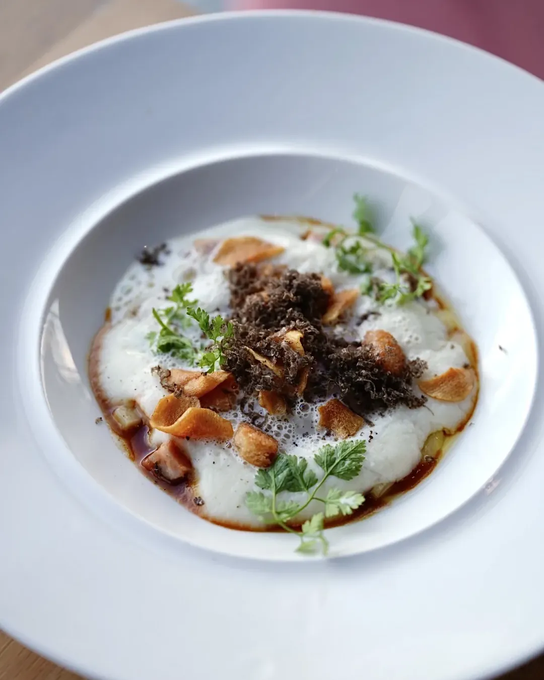 Mousseline, grated black truffle and Jerusalem artichoke crisps